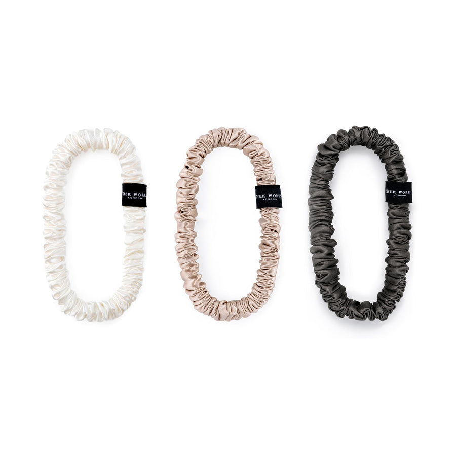Set of three Silk Works mulberry silk scrunchies in ivory, caramel, and charcoal grey – soft, gentle, and perfect for everyday styling