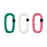 Set of 3 slim silk scrunchies in green, ivory, and watermelon pink – designed to reduce hair breakage, frizz, and creases