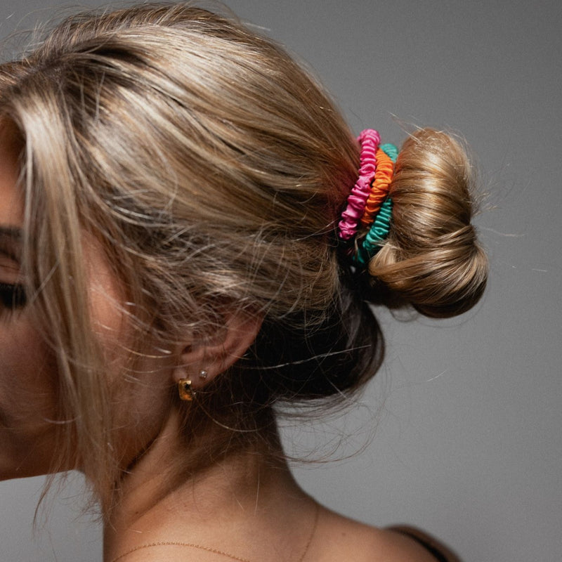 lady with three silk skinny scrunchies in her hair