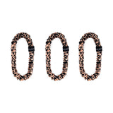 Trio of rose gold leopard 100% mulberry silk skinny scrunchies by Silk Works, designed to reduce breakage and frizz.