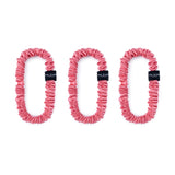 Trio of watermelon pink 100% mulberry silk skinny scrunchies by Silk Works, designed to reduce breakage and frizz.