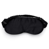 Black mulberry silk sleep mask by Silk Works with soft ruched strap and discreet logo tag, designed for light blocking and skin comfort.
