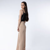Woman wearing a black silk camisole paired with camel trousers – showcasing the elegant sheen and drape of mulberry silk