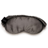 Charcoal grey mulberry silk sleep mask by Silk Works with soft ruched strap and discreet logo tag, designed for light blocking and skin comfort.