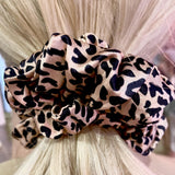 Leopard print mulberry silk scrunchie in hair – soft, smooth, and providing a gentle hold for a stylish, crease-free look.