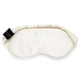 Ivory mulberry silk sleep mask by Silk Works with soft ruched strap and discreet logo tag, designed for light blocking and skin comfort.