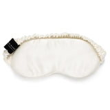 Ivory mulberry silk sleep mask by Silk Works with soft ruched strap and discreet logo tag, designed for light blocking and skin comfort.