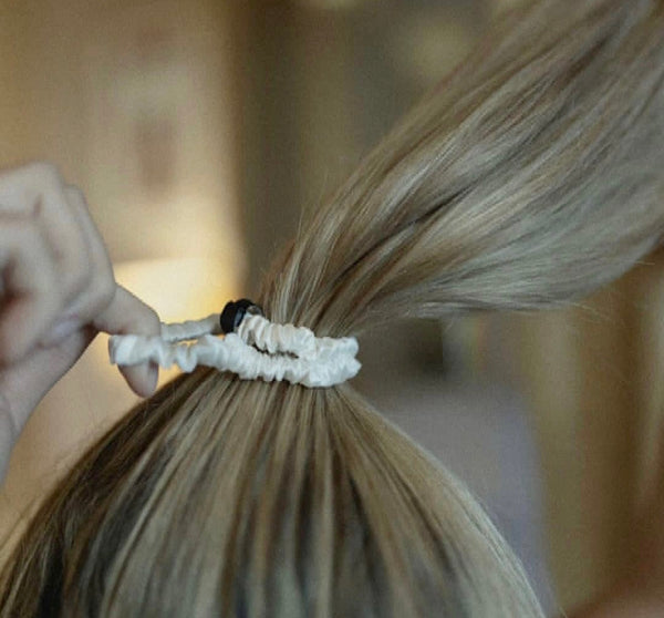 Ivory silk scrunchie in a blonde lady's hair.