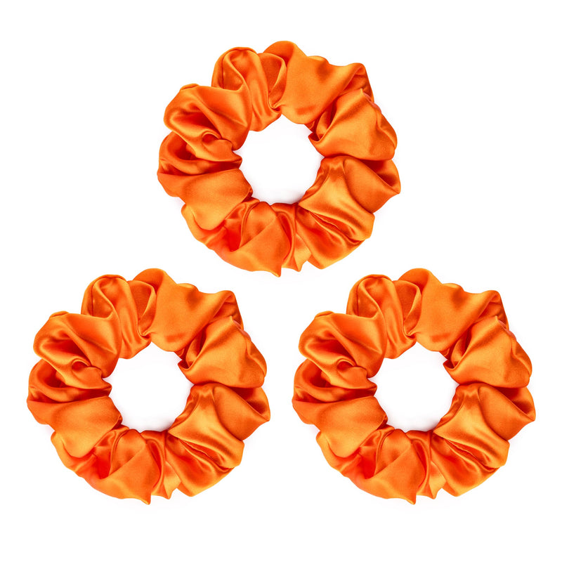 Set of three bright orange large silk scrunchies.