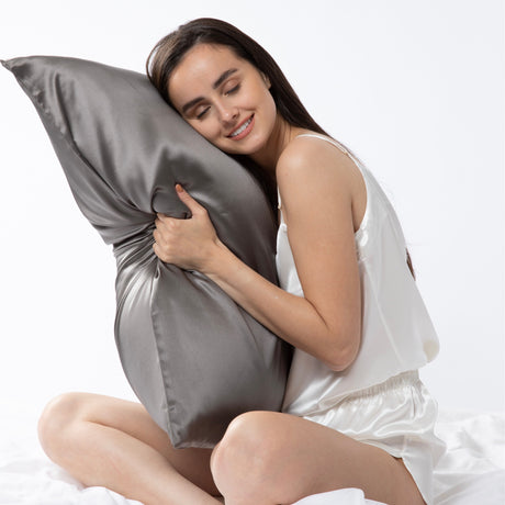 A lady hugging a pure mulberry silk works London pillowcase