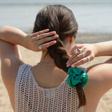 Mulberry silk scrunchie in jade green worn in braided hair at the beach