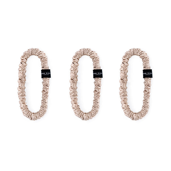 Trio of carame 100% mulberry silk skinny scrunchies by Silk Works, designed to reduce breakage and frizz.