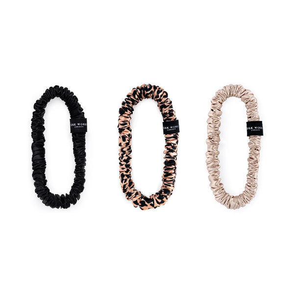 Set of three Silk Works London mulberry silk skinny scrunchies in black, leopard print, and caramel – soft, smooth, and perfect for reducing hair breakage and creases.