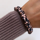 leopard print silk skinny scrunchie on wrist