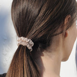 lady wearing caramel silk skinny scrunchie in hair