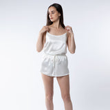 Lady wearing ivory silk shorts and camisole top