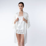 Lady wearing ivory silk shorts and cami top and ivory silk robe