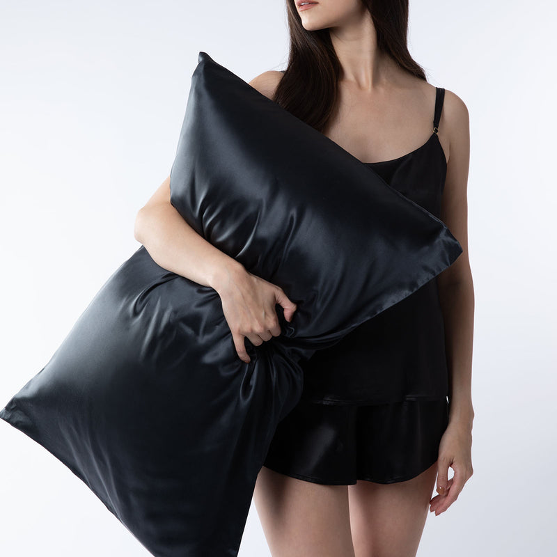 lady holding black silk pillowcase
