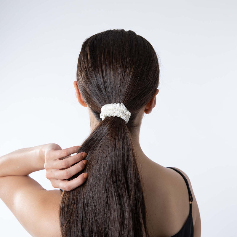 Lady wearing skinny silk ivory scrunchie in hair