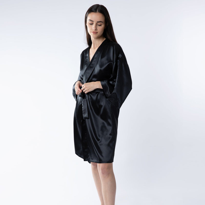 Woman wearing a 100% mulberry silk black robe – showcasing its smooth texture and elegant drape for a luxurious, sophisticated look