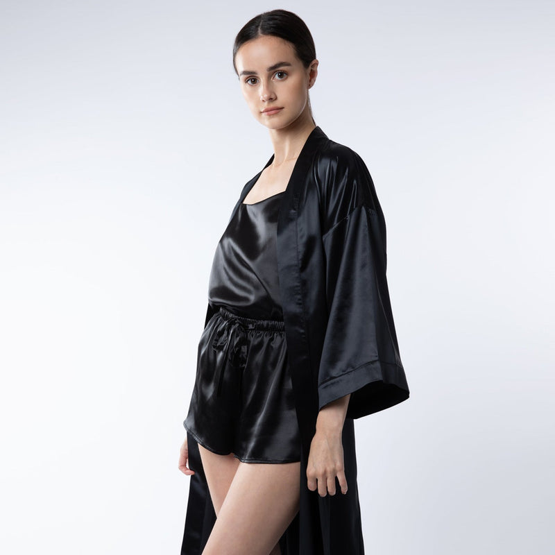 Woman wearing black mulberry silk shorts and cami set – soft, elegant, and perfect for a luxurious loungewear experience.