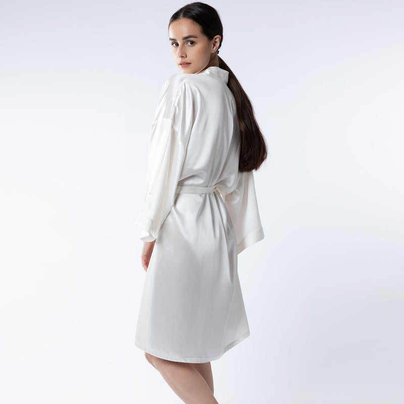 Woman wearing Silk Works London mulberry silk ivory robe – showcasing its soft, luxurious texture and elegant fit