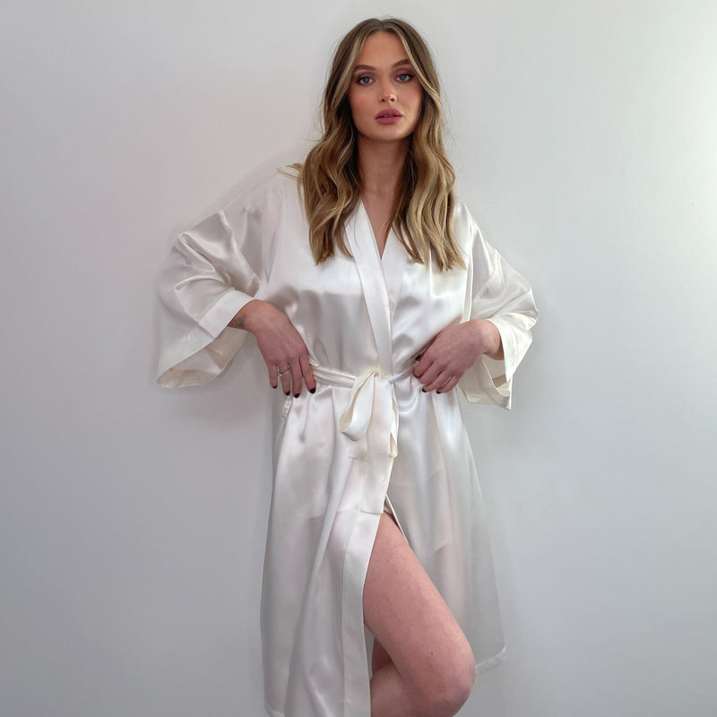 Woman wearing an ivory bridal-inspired silk robe – elegant and soft, perfect for pre-wedding moments or special occasions