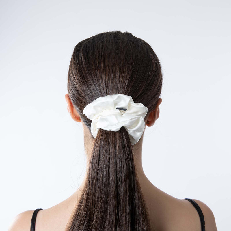 lady wearing mulberry silk large white scrunchie in hair