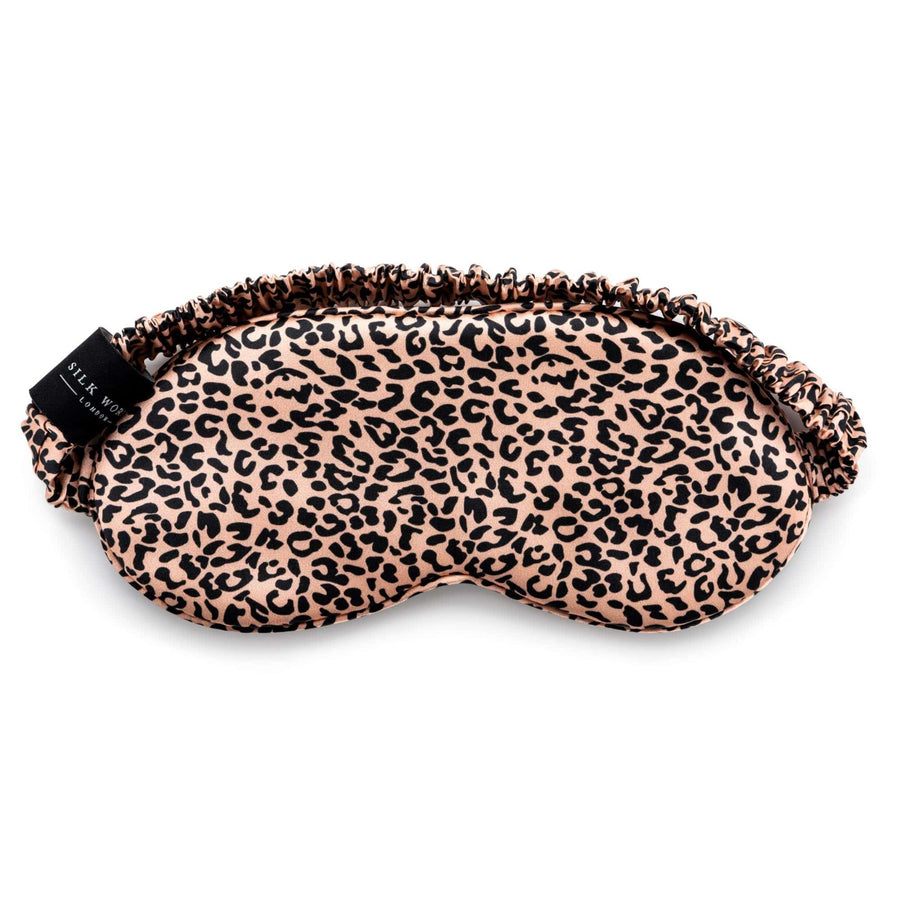 Rose Gold leopard print mulberry silk sleep mask by Silk Works with soft ruched strap and discreet logo tag, designed for light blocking and skin comfort.